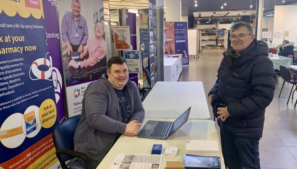 Lewis and John at the NETRALT stand in the Vaccination Hub, Bon Accord Centre, Aberdeen